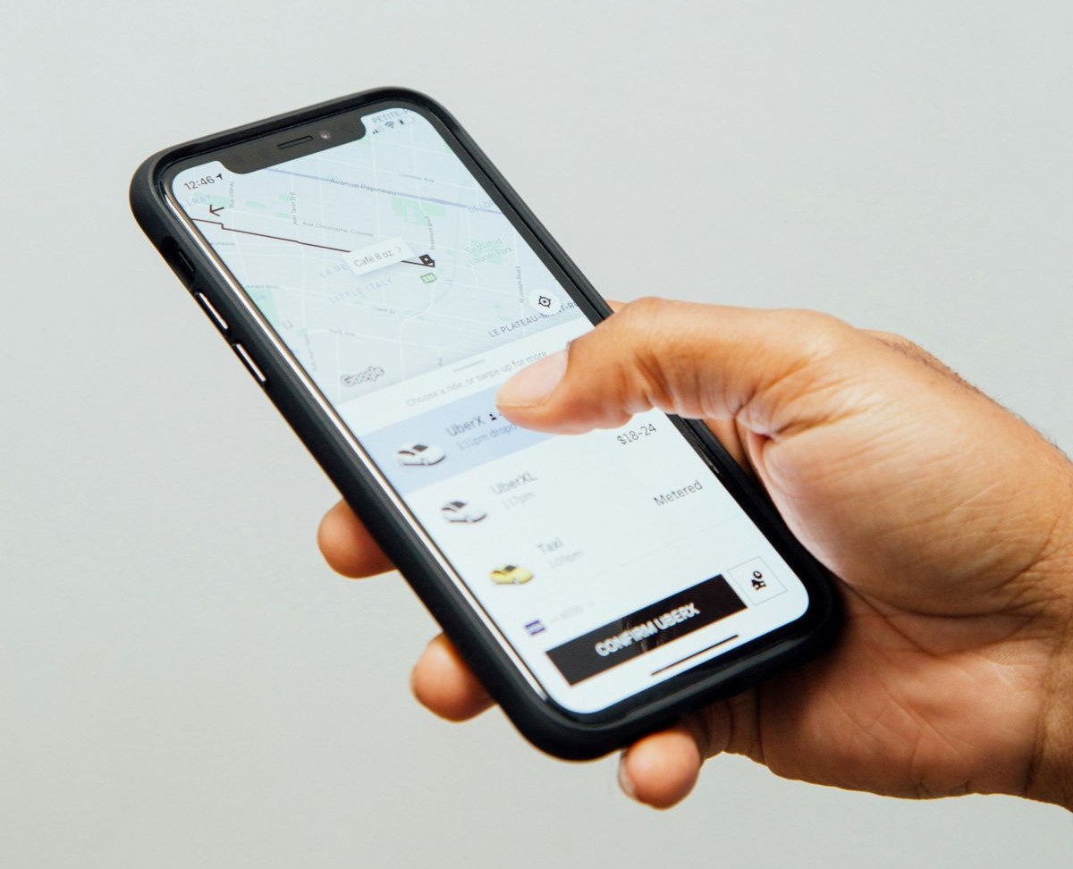 Hand holding phone showing Uber on screen