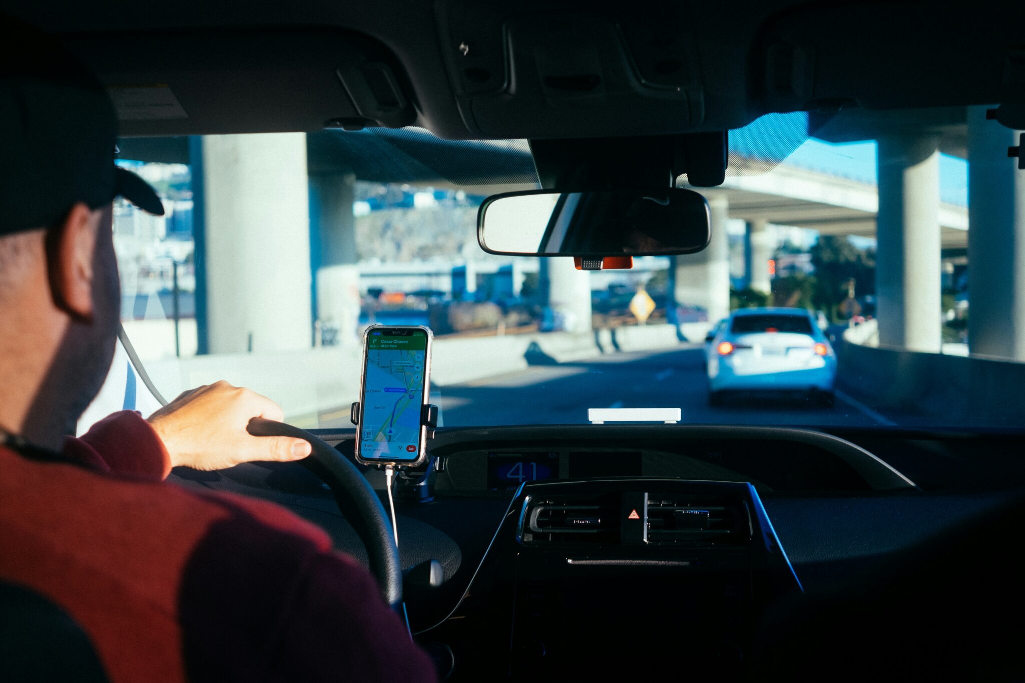 man in car with navigation on phone